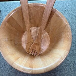 Large wooden salad bowl with fork and spoon
